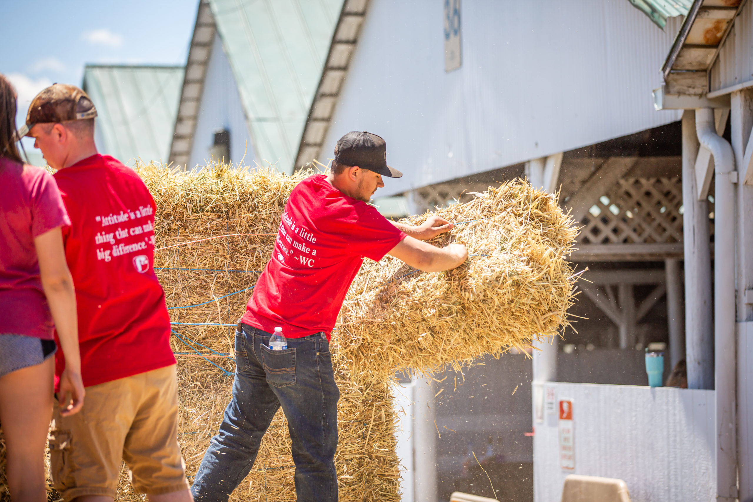 Straw making and men tossing from trailer